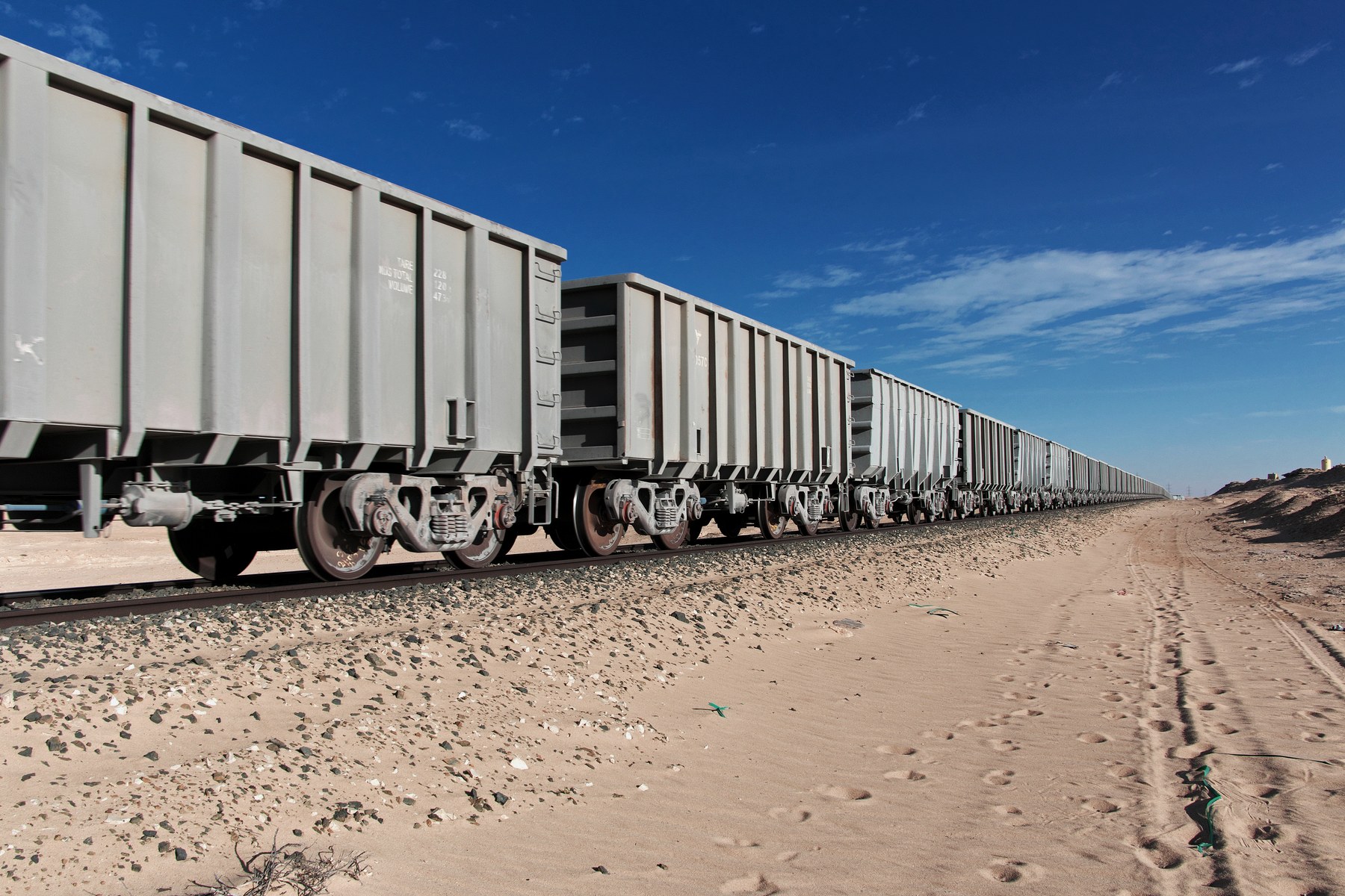Open-cut mine in Africa: layered rock face and haul truck